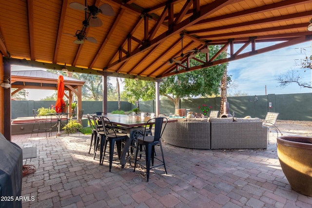 view of patio featuring a gazebo, ceiling fan, and an outdoor hangout area