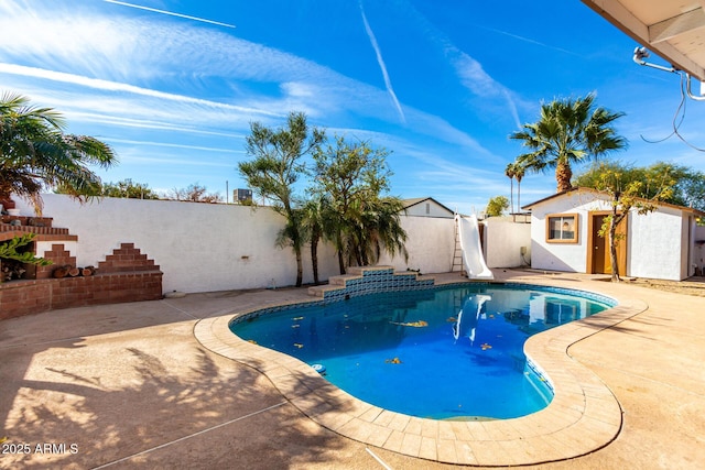 view of swimming pool featuring an outdoor structure and a patio area