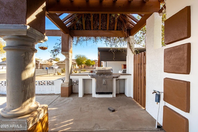 view of patio / terrace with exterior kitchen, a gazebo, and grilling area