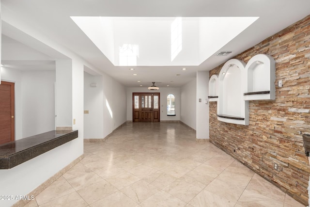 entryway featuring a towering ceiling