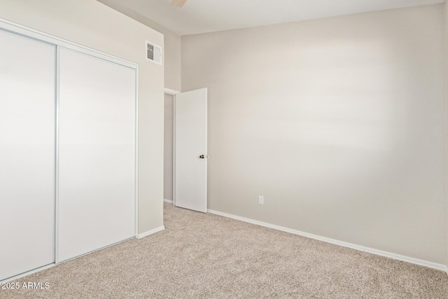 2301 E University Dr Unit 172, Mesa, AZ 85213 - unfurnished bedroom featuring light colored carpet, a closet, baseboards, and ceiling fan