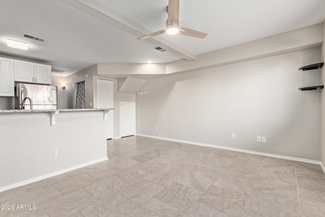 2301 E University Dr Unit 172, Mesa, AZ 85213 - unfurnished living room featuring a ceiling fan and baseboards