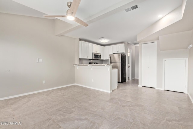2301 E University Dr Unit 172, Mesa, AZ 85213 - kitchen with stainless steel appliances, a peninsula, a ceiling fan, white cabinetry, and baseboards