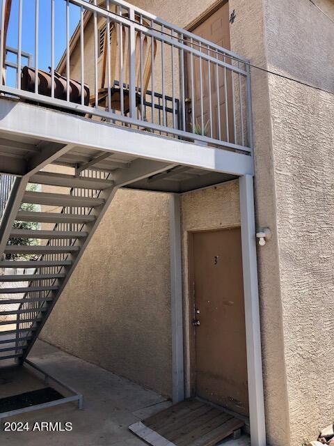 doorway to property featuring stucco siding