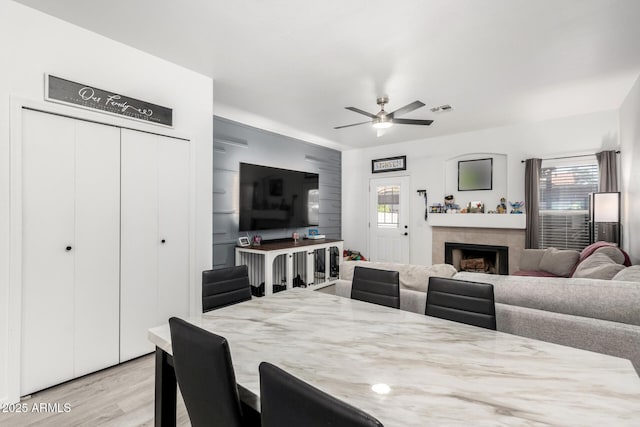 1961 N Hartford St Unit 1092, Chandler, AZ 85225 - dining space with plenty of natural light, light wood finished floors, ceiling fan, and a fireplace