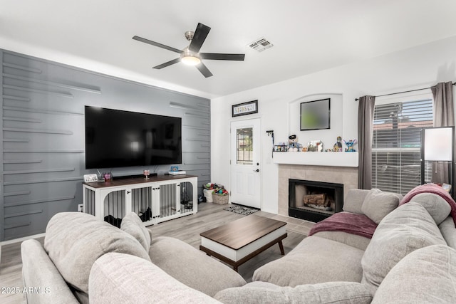 1961 N Hartford St Unit 1092, Chandler, AZ 85225 - living room featuring a ceiling fan, wood finished floors, and a tiled fireplace