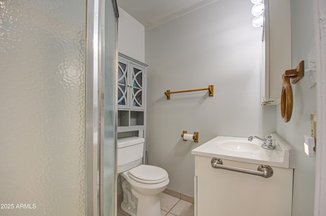 bathroom with toilet, tile patterned flooring, ornamental molding, and vanity