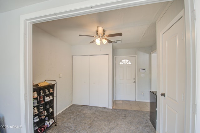 bedroom with carpet floors, a closet, visible vents, and ceiling fan