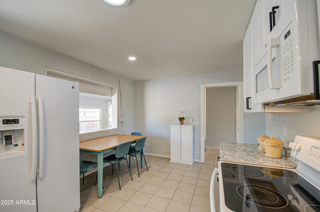 kitchen with white appliances, light tile patterned flooring, white cabinetry, backsplash, and recessed lighting