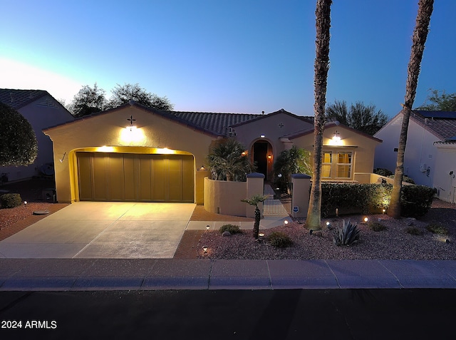 mediterranean / spanish-style house featuring a garage