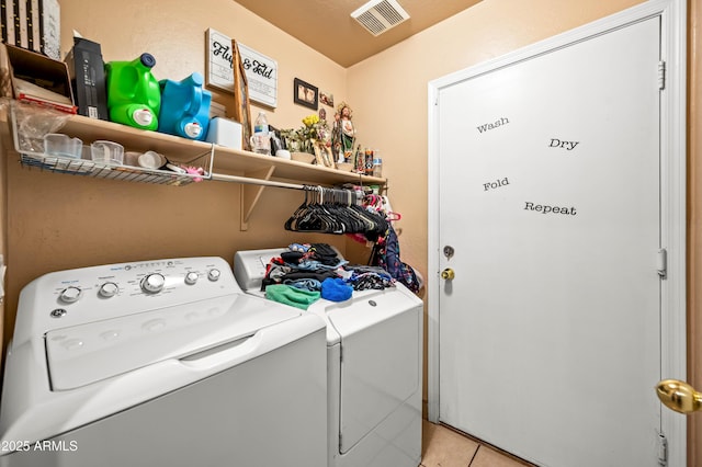 laundry room with laundry area, visible vents, washing machine and clothes dryer, and light tile patterned floors