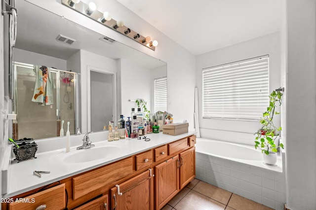 full bathroom featuring a stall shower, tile patterned flooring, visible vents, and vanity