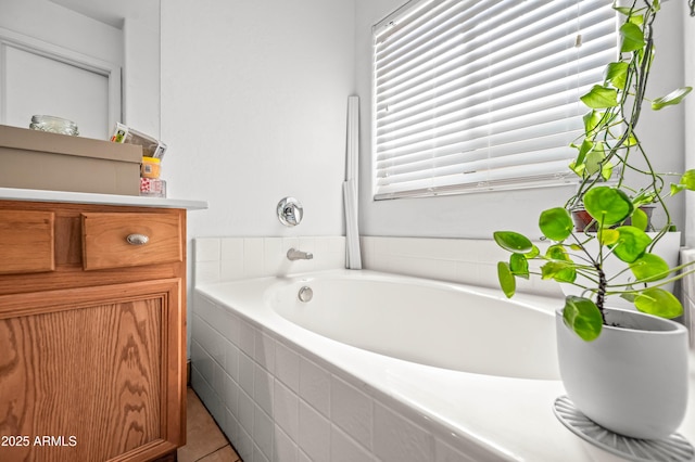 bathroom with a garden tub and vanity