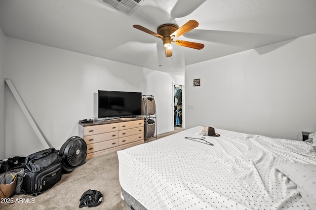 carpeted bedroom featuring a ceiling fan and visible vents