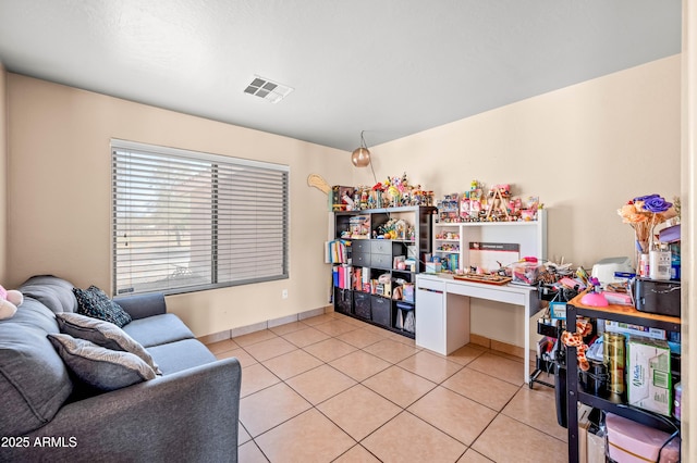 office space featuring visible vents, baseboards, and light tile patterned floors