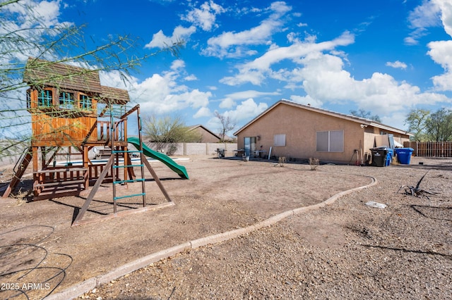 view of jungle gym featuring fence