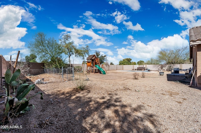 view of yard featuring a fenced backyard and a playground