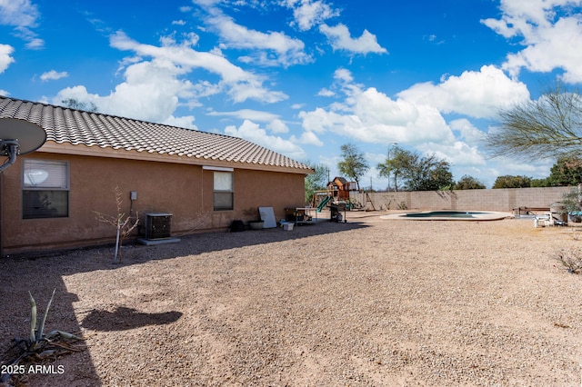 view of yard with fence and a playground