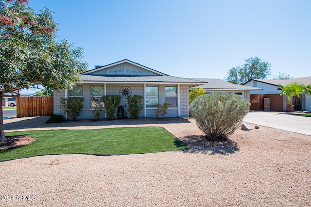 ranch-style house with a front lawn