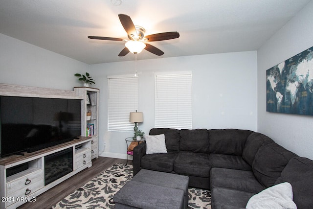 living room featuring ceiling fan and dark hardwood / wood-style flooring