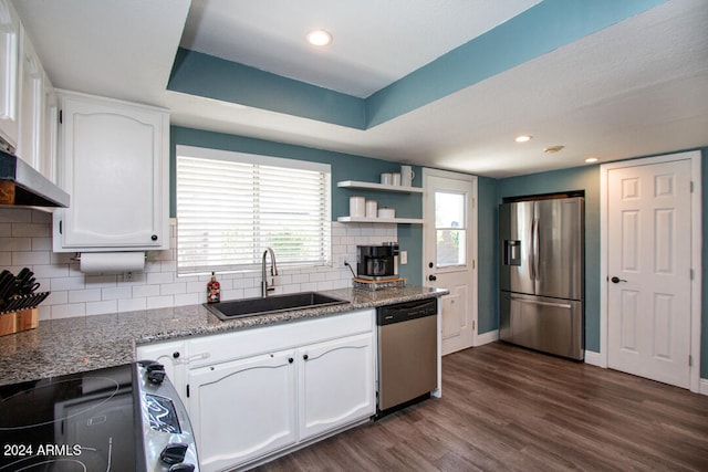 kitchen featuring backsplash, sink, white cabinetry, appliances with stainless steel finishes, and dark hardwood / wood-style flooring