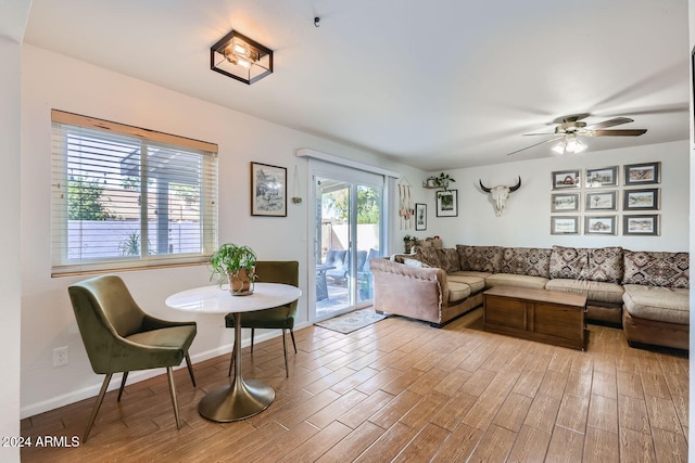 living room featuring light hardwood / wood-style floors and ceiling fan