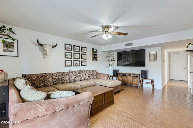 living room with ceiling fan and light wood-type flooring