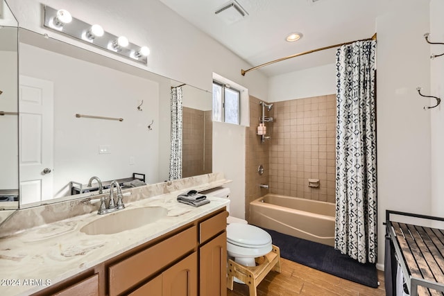 full bathroom with vanity, toilet, shower / bathtub combination with curtain, and hardwood / wood-style floors