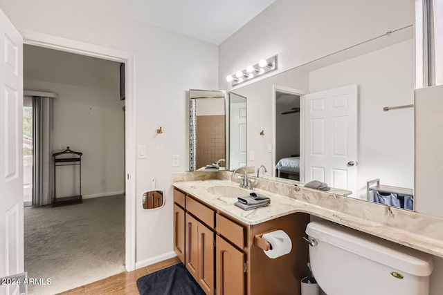 bathroom featuring vanity, hardwood / wood-style floors, and toilet