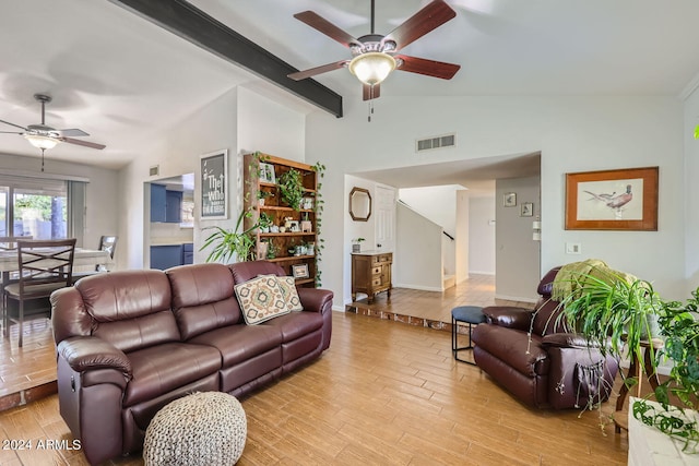 living room with light hardwood / wood-style floors, vaulted ceiling with beams, and ceiling fan