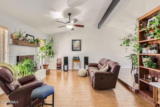 living room with light hardwood / wood-style floors, lofted ceiling with beams, ceiling fan, and a brick fireplace