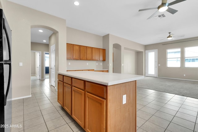 1422 E Ebony Dr, Chandler, AZ 85286 - kitchen with visible vents, light tile patterned floors, arched walkways, a ceiling fan, and freestanding refrigerator