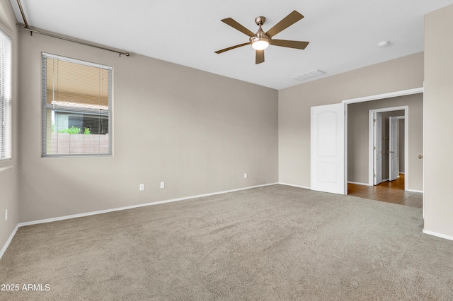 1422 E Ebony Dr, Chandler, AZ 85286 - spare room featuring carpet floors, a ceiling fan, visible vents, and a healthy amount of sunlight