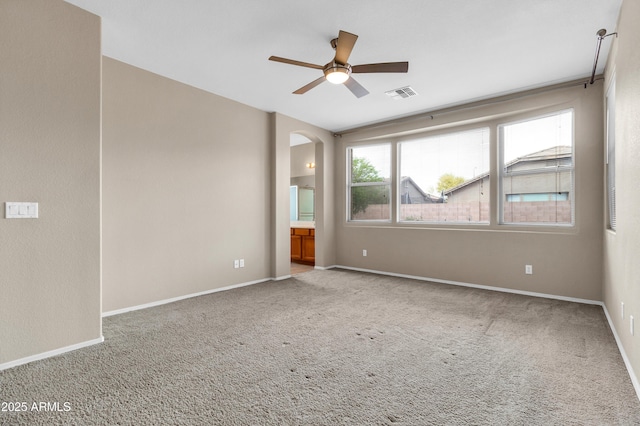 1422 E Ebony Dr, Chandler, AZ 85286 - carpeted empty room featuring arched walkways, ceiling fan, baseboards, and visible vents