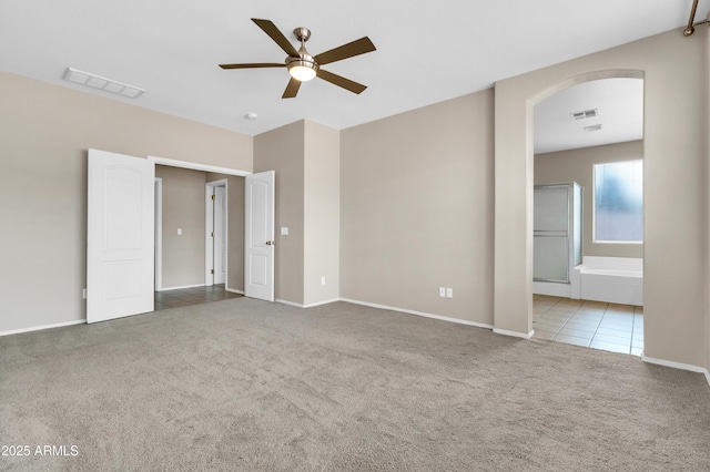 1422 E Ebony Dr, Chandler, AZ 85286 - unfurnished bedroom featuring visible vents, arched walkways, carpet flooring, and tile patterned flooring
