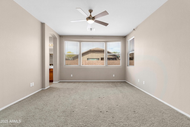 1422 E Ebony Dr, Chandler, AZ 85286 - carpeted empty room featuring arched walkways, baseboards, a ceiling fan, and visible vents