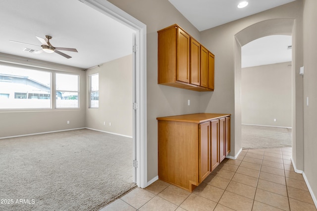1422 E Ebony Dr, Chandler, AZ 85286 - hall with arched walkways, visible vents, light carpet, light tile patterned flooring, and baseboards
