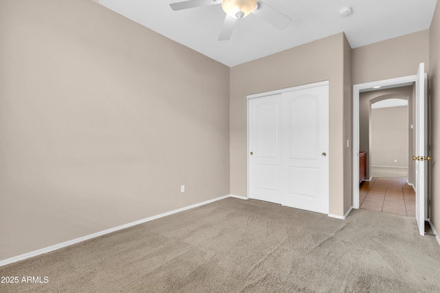 1422 E Ebony Dr, Chandler, AZ 85286 - unfurnished bedroom featuring a closet, baseboards, arched walkways, ceiling fan, and carpet floors