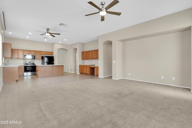 1422 E Ebony Dr, Chandler, AZ 85286 - unfurnished living room with arched walkways, a ceiling fan, visible vents, recessed lighting, and light carpet