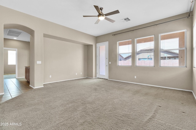 1422 E Ebony Dr, Chandler, AZ 85286 - carpeted empty room with visible vents, ceiling fan, arched walkways, and baseboards