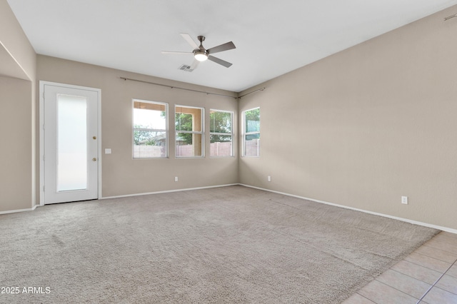 1422 E Ebony Dr, Chandler, AZ 85286 - carpeted spare room featuring visible vents, baseboards, a ceiling fan, and tile patterned flooring