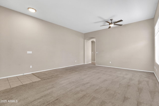 1422 E Ebony Dr, Chandler, AZ 85286 - carpeted spare room with arched walkways, ceiling fan, baseboards, and a wealth of natural light