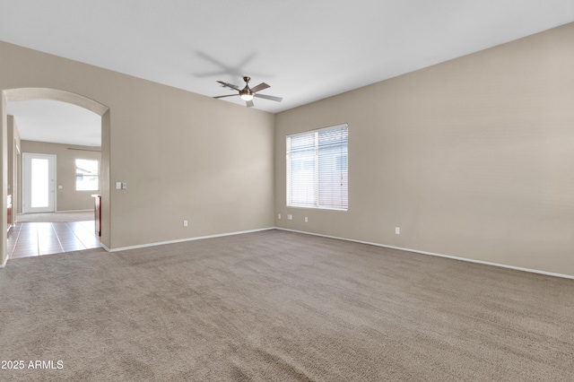 1422 E Ebony Dr, Chandler, AZ 85286 - carpeted spare room featuring arched walkways, ceiling fan, and baseboards
