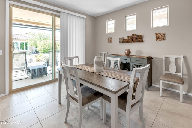 dining room with baseboards and light tile patterned floors