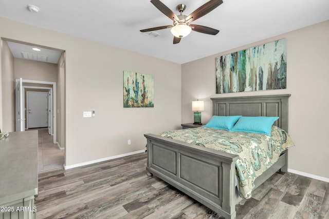 bedroom with baseboards, wood finished floors, and a ceiling fan