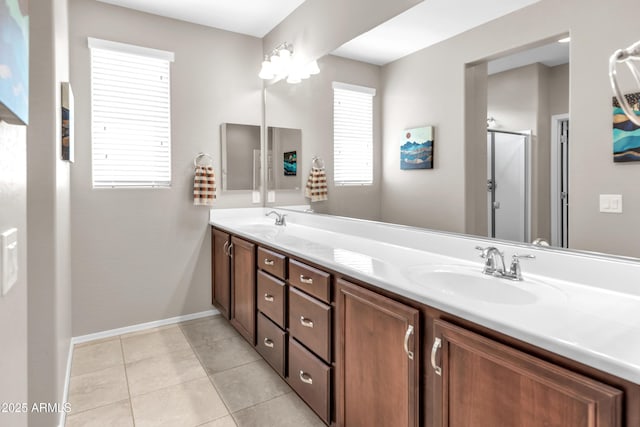 full bathroom with a shower stall, double vanity, tile patterned flooring, and a sink