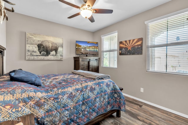 bedroom with baseboards, ceiling fan, and wood finished floors