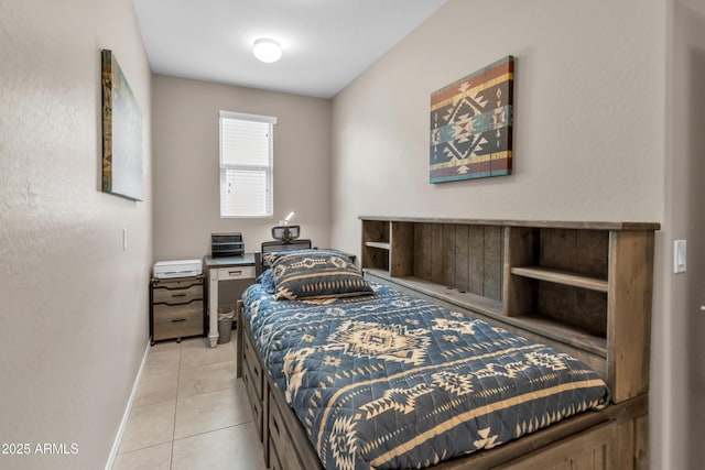 bedroom featuring baseboards and light tile patterned floors