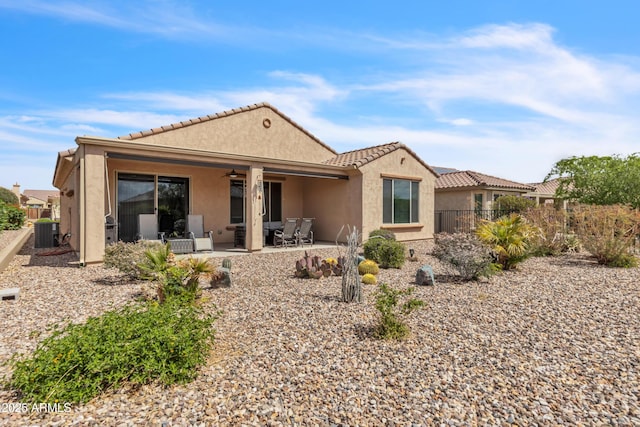rear view of property featuring stucco siding, central air condition unit, a patio, fence, and ceiling fan