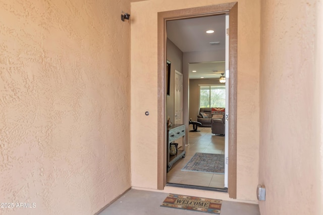 entrance to property featuring stucco siding